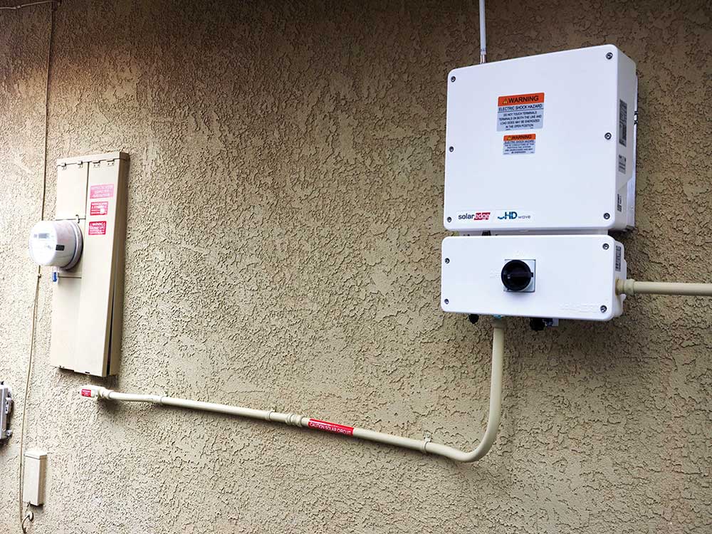 Photo 2. Do the ac power source output conductors from the inverter to the circuit breaker in the service panelboard meet the requirements of NEC 240.4(D)(7)?
