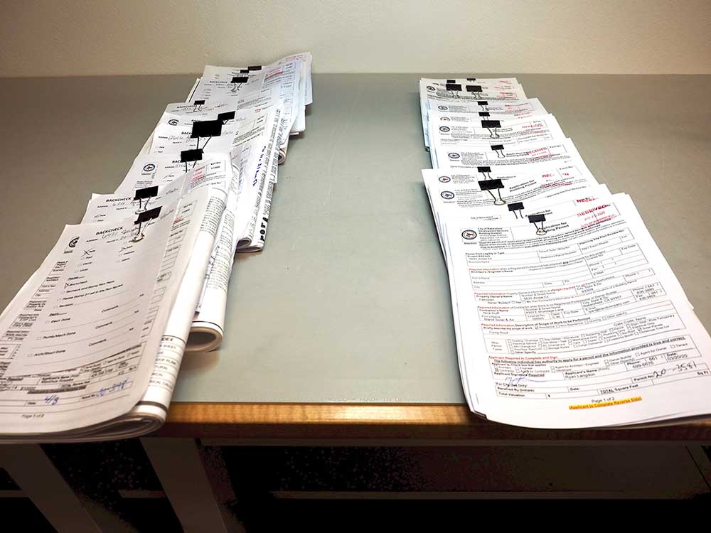 Photo 4. The PV plans on the left are “revisions” meaning that the original version did not meet code rules or the installer was not able to follow the approved plan. Revisions average up to 50% of daily submissions.