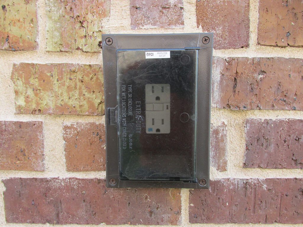 Photo 2c. A wet location cover with the receptacle marked weather-resistant (WR).