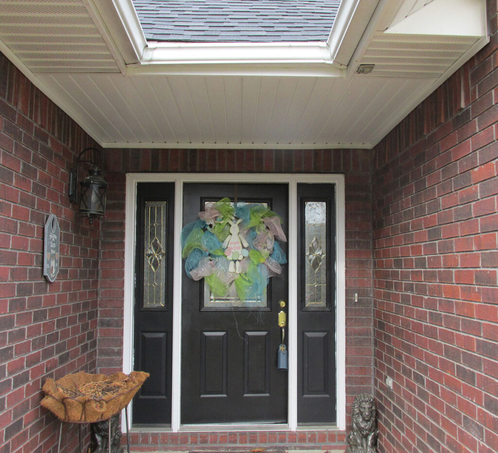 Photo 1d. A porch location where the receptacle outlet on the porch and in the soffit have been determined to be in a damp location by the AHJ.