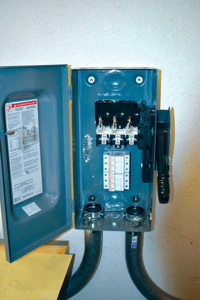 Photo 6. Workstation interface disconnect to 380 VDC bus. Midget fuse holders rated at 30A are located below the witch mechanism. Courtesy of John Wiles