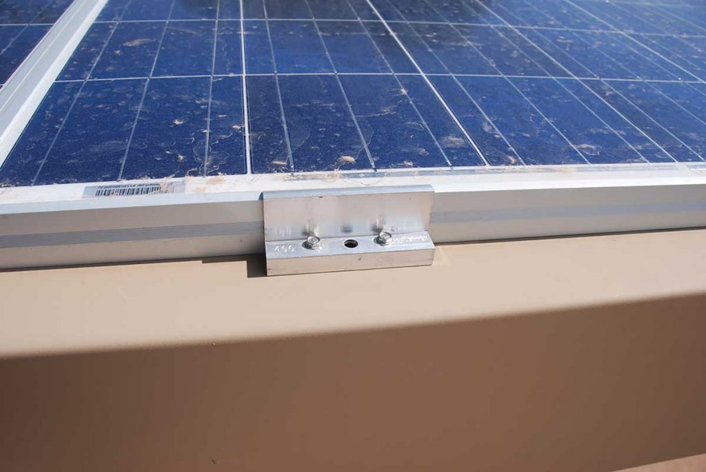 Photo 1. Top clip mounting device attaching the module to the rack. Note the listing may have been violated where two extra holes were drilled to attach the clip. Courtesy of John Wiles