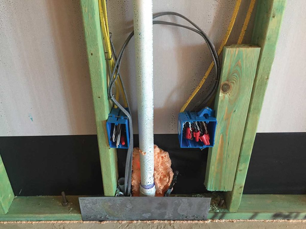 Photo 6. The rough-in stage of Type UF cable installed in a PVC raceway under a concrete slab to a kitchen island location.